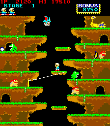 Screenshot from the Konami game Roc’n Rope, showing the player in an earth-and-grass-colored level with a black background. 