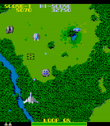 Screenshot of the game Wyvern F-0. A top-town shooter showing a fighter jet above a green landscape. 