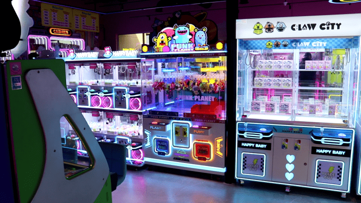 Interior of Claw City in Katy, TX, with heavy neon lighting and a techno-future aesthetic. 